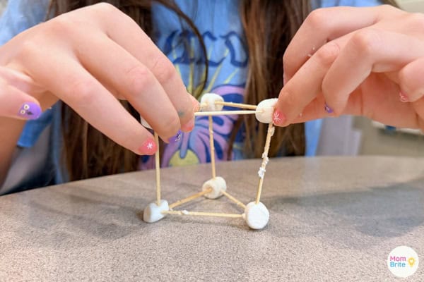 Kids building simple shapes with marshmallows and toothpicks
