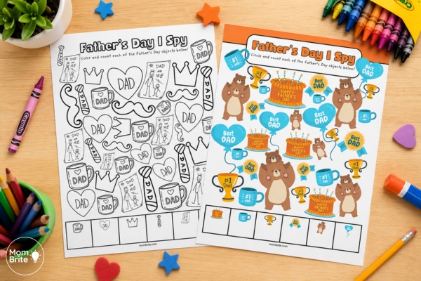 Father’s Day I Spy worksheets on a kid’s desk with crayons and craft supplies, featuring one black-and-white coloring page and one colorful counting activity